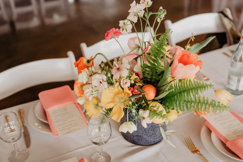 A sophisticated table setting with a vibrant floral centerpiece.