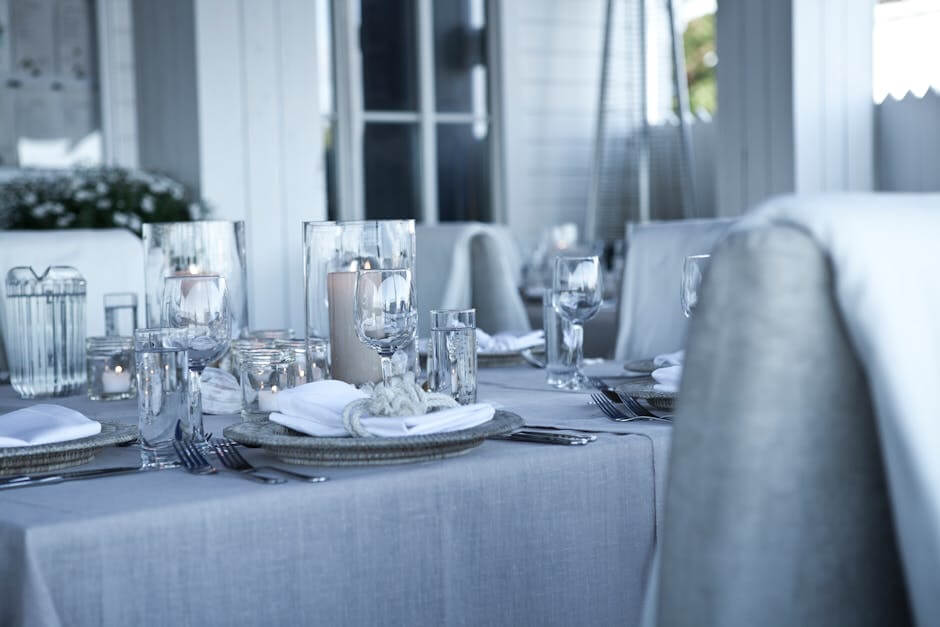 A beautifully set dining table with elegant candlelight ambiance for a luxurious dinner experience.
